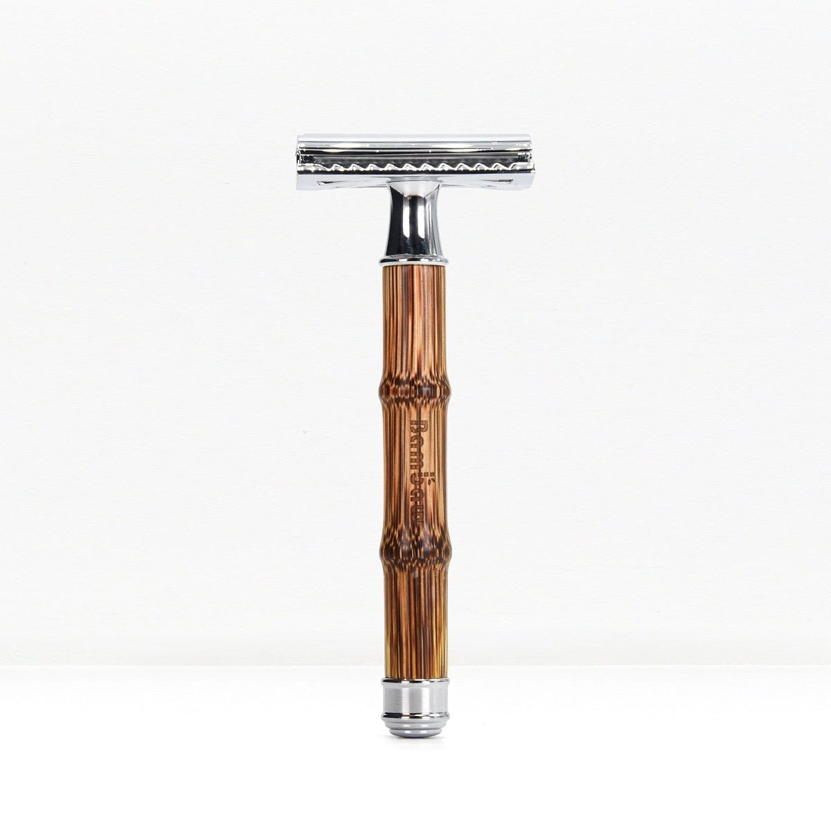Bamboo safety razor with glossy brown bamboo handle and polished chrome head on a white backdrop