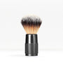 Shaving brush with a knurled black handle and dense light to dark bristles against a white background