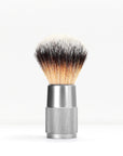 Shaving brush with a silver metal handle and knurled grip against a white background
