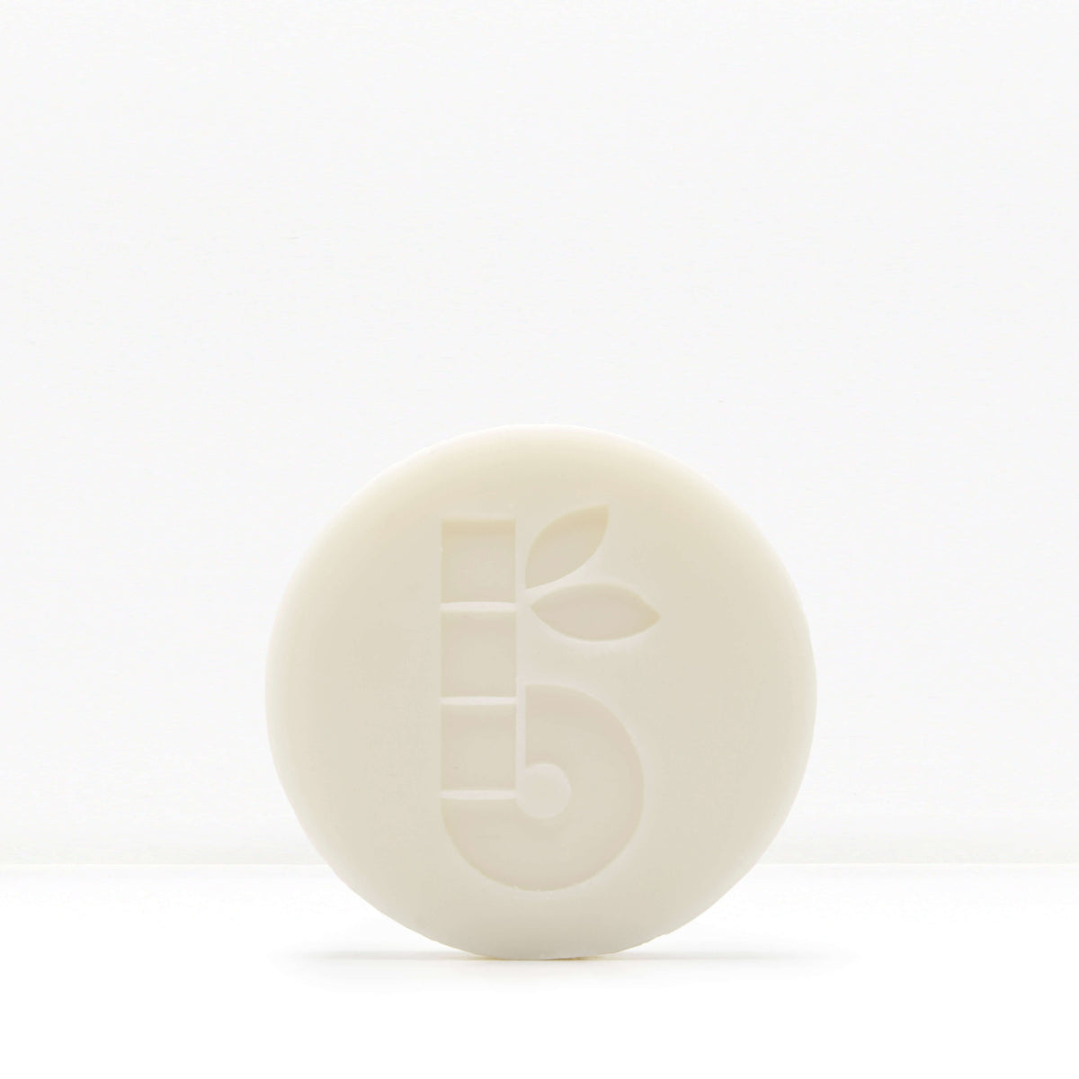 White shaving bar with a subtle embossed pattern on a pale background