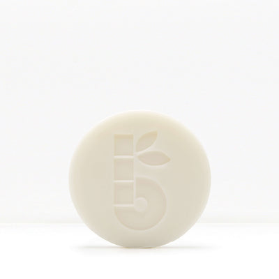 White shaving bar with a subtle embossed pattern on a pale background