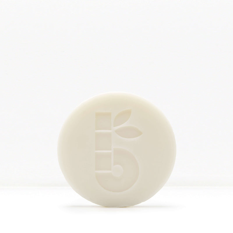 White shaving bar with a subtle embossed pattern on a pale background