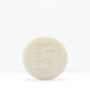 White shaving bar with a subtle embossed pattern on a pale background