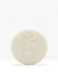 White shaving bar with a subtle embossed pattern on a pale background