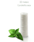 50 meters Candellila wax floss spool with mint leaves beside it